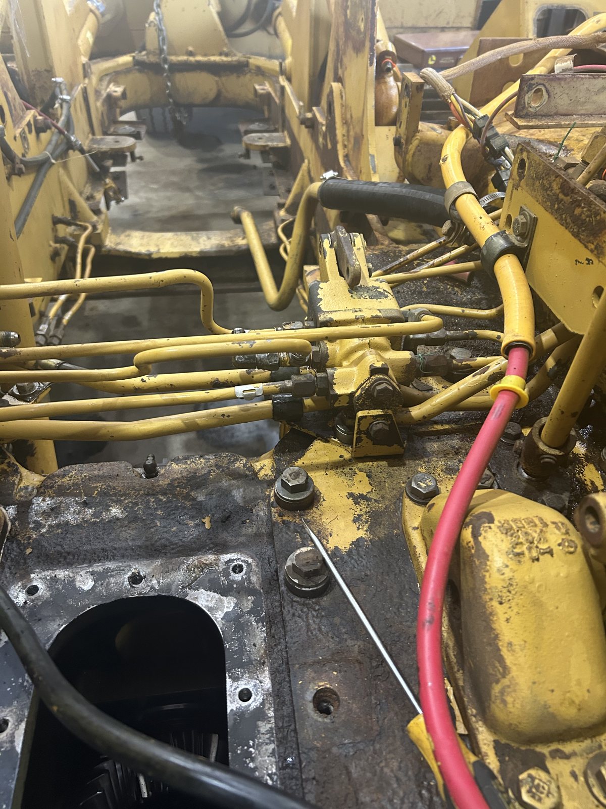 Hydraulic plumbing and wiring under a machine’s deck.