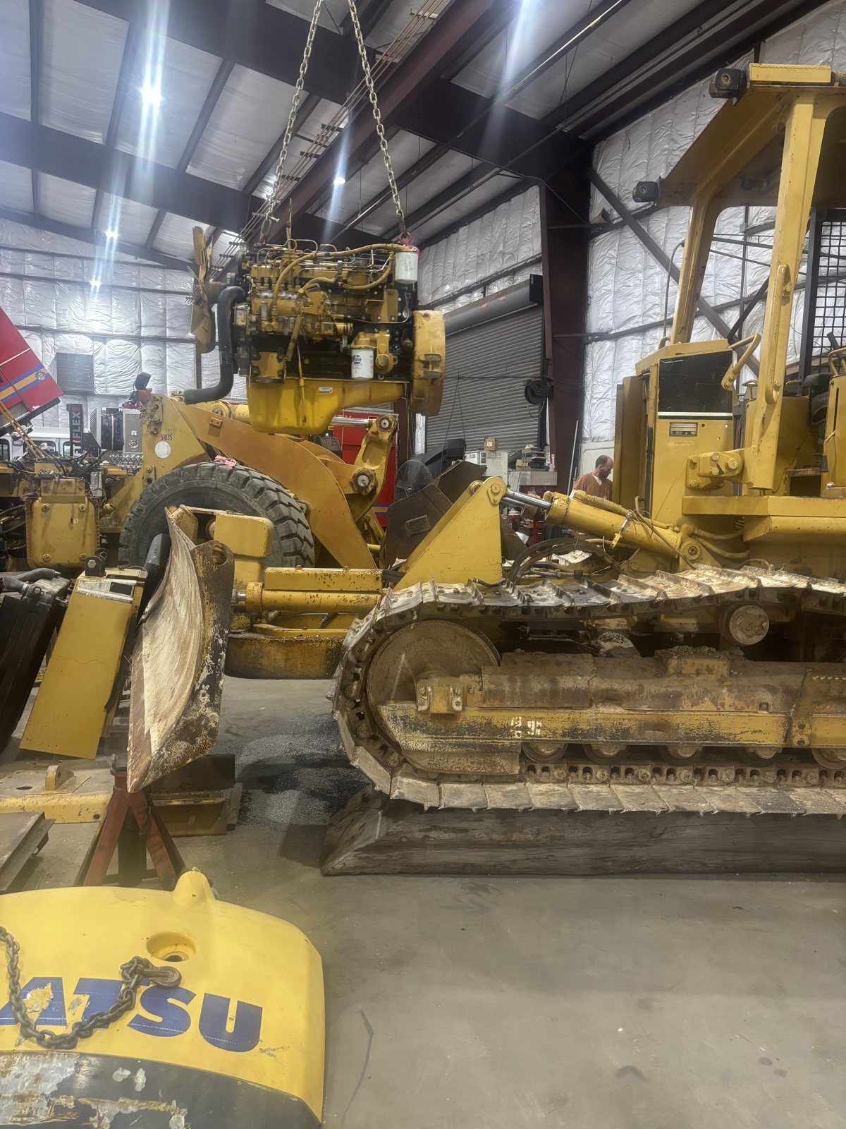 A Komatsu excavator parked in a shop bay