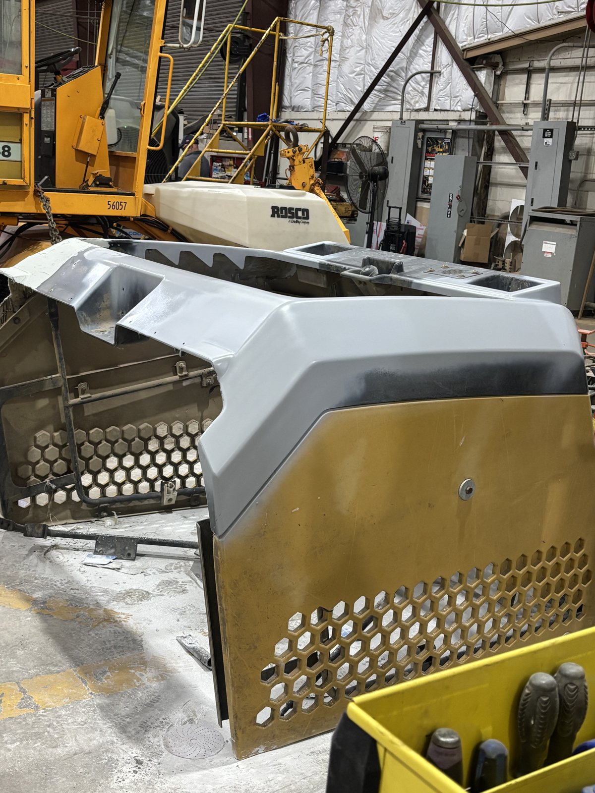 Equipment hood panel with a tool cart behind