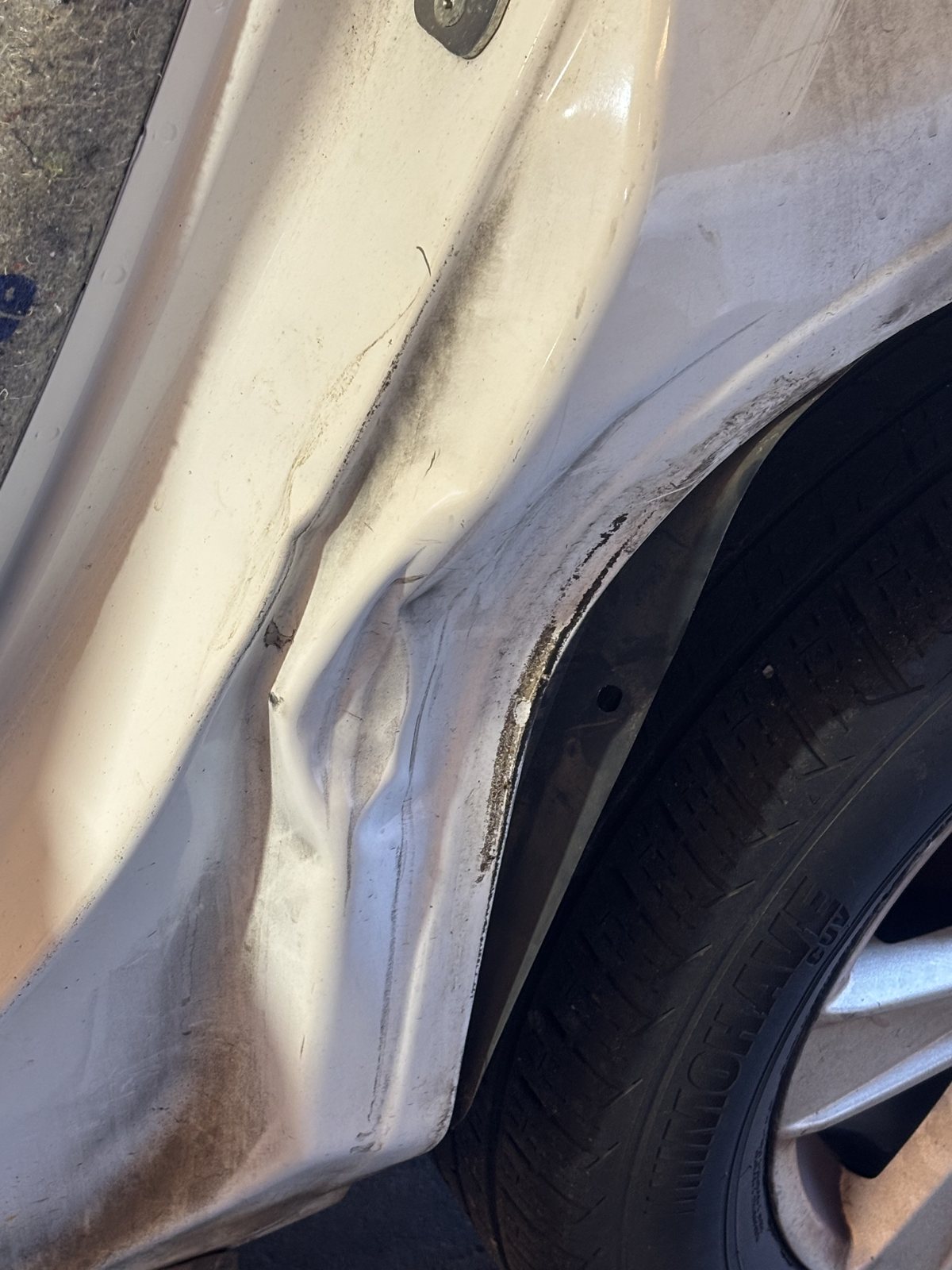 Pickup rear wheel arch with the filler sanded, mid-repair.